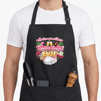 Tablier de cuisine noir avec inscription Amies aujourd'hui Témoins demain EVJF entourée de champagne et de fleurs roses.