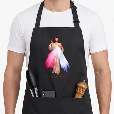 Tablier de cuisine noir avec une illustration du Divin Miséricorde et l'inscription Jésus j'ai confiance en Toi en bas.