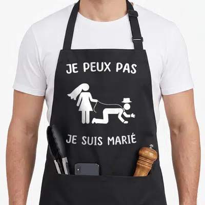 Tablier de cuisine noir avec inscription Je peux pas je suis marié et silhouette d'un homme attaché à sa femme.
