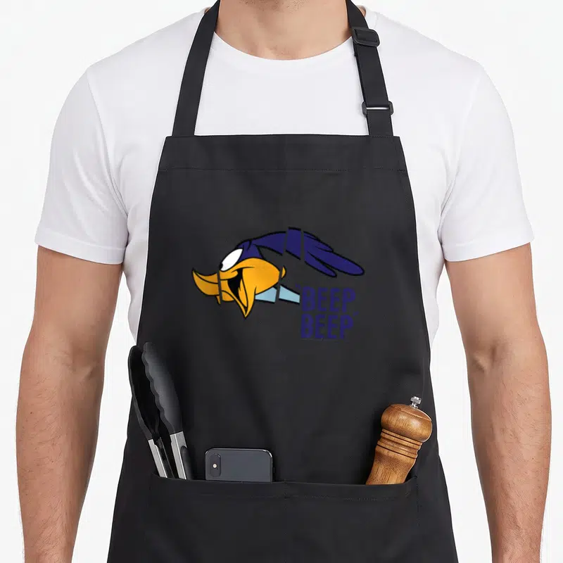 Tablier de cuisine noir avec illustration du Road Runner volant et texte Beep Beep en bleu.