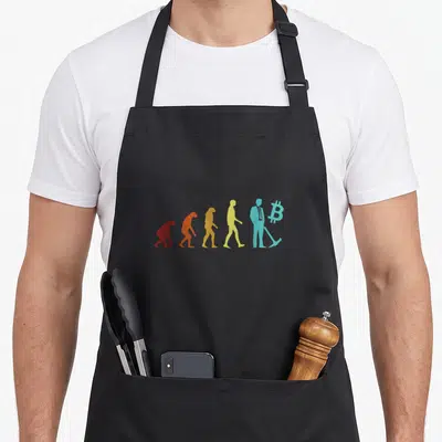 Tablier de cuisine noir avec une illustration colorée représentant l'évolution humaine se terminant par un mineur Bitcoin.