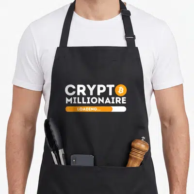 Tablier de cuisine noir avec inscription Crypt Millionnaire Loading et icône Bitcoin orange.