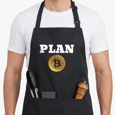 Tablier de cuisine noir avec l'inscription PLAN et une illustration de pièce Bitcoin dorée.