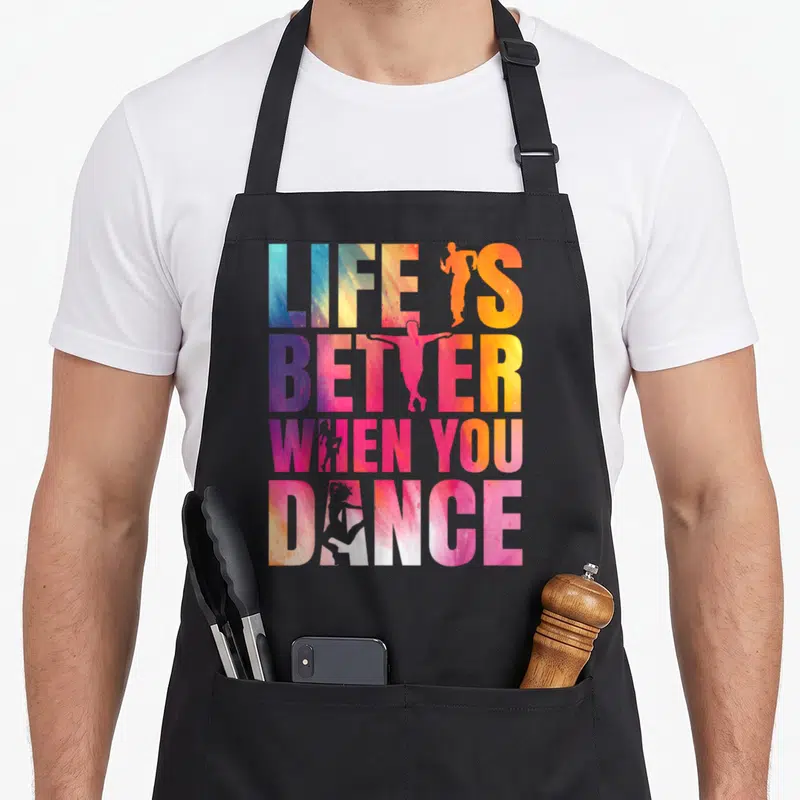 Tablier de cuisine noir avec inscription Life is better when you dance et silhouettes de danseurs colorées.
