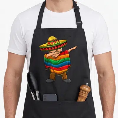 Tablier de cuisine noir avec illustration d'un garçon en poncho mexicain et sombrero faisant le dab dance.