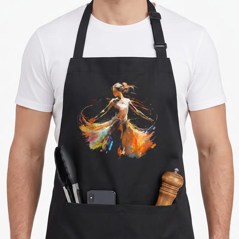 Tablier de cuisine noir avec une ballerine aux éclaboussures de peinture orange, jaune et bleue.