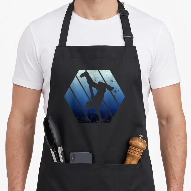 Tablier de cuisine noir avec motif hexagonal bleu représentant une silhouette de breakdanceur en mouvement acrobatique.