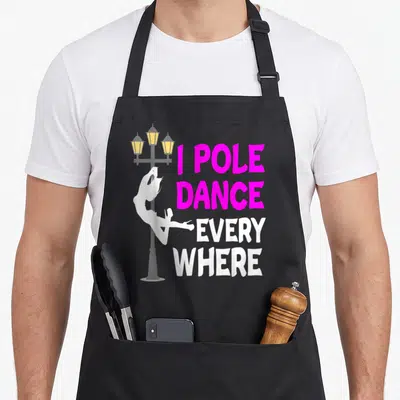 Tablier de cuisine noir avec silhouette blanche sur réverbère et texte rose vif I Pole Dance Every Where