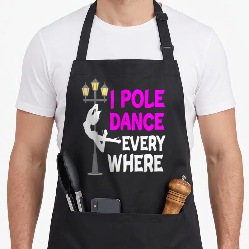 Tablier de cuisine noir avec silhouette blanche sur réverbère et texte rose vif I Pole Dance Every Where