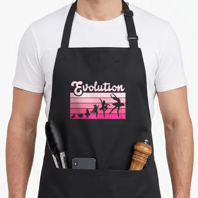 Tablier de cuisine noir avec illustration Evolution et silhouettes de danseuses sur fond rose dégradé à bandes horizontales.