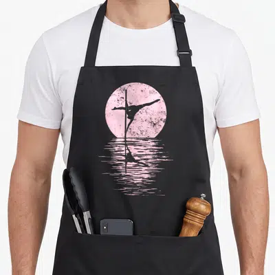 Tablier de cuisine noir avec silhouette rose d'une danseuse au pôle et son reflet sur l'eau.