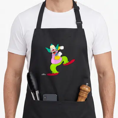 Tablier de cuisine noir avec Krusty le clown aux cheveux verts en train de danser joyeusement