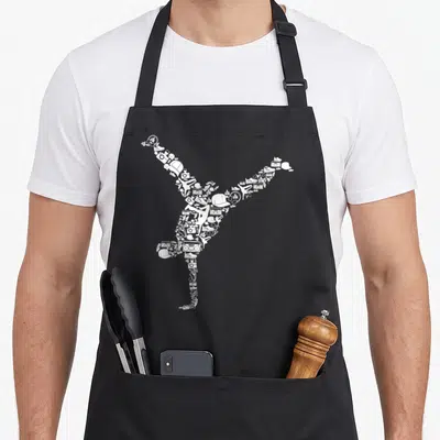 Tablier de cuisine noir avec silhouette de breakdancer composée d'icônes urbaines blanches comme casquettes et boombox.