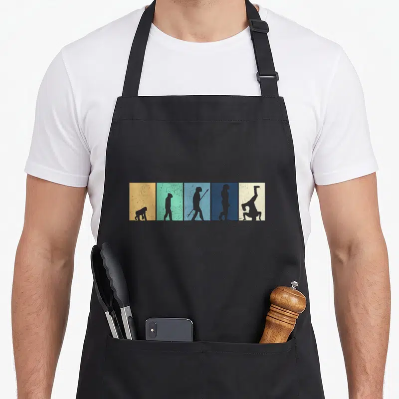 Tablier de cuisine noir avec cinq rectangles colorés montrant l'évolution d'un singe en un breakdancer en position freeze.