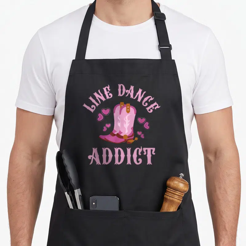 Tablier de cuisine noir avec bottes roses, cœurs et texte Line Dance Addict imprimé en rose