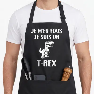 Tablier de cuisine noir avec illustration blanche d'un petit Tyrannosaure et le texte Je m'en fous je suis un T-Rex.
