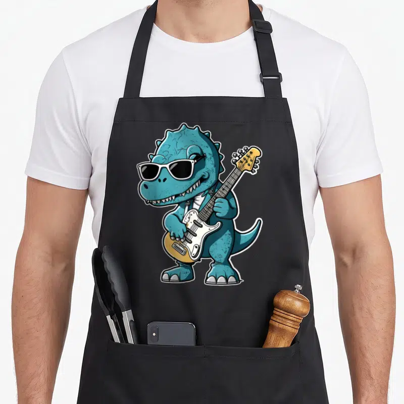 Tablier de cuisine noir avec dinosaure bleutenant des lunettes noires et tenant une guitare électrique jaune et blanche.