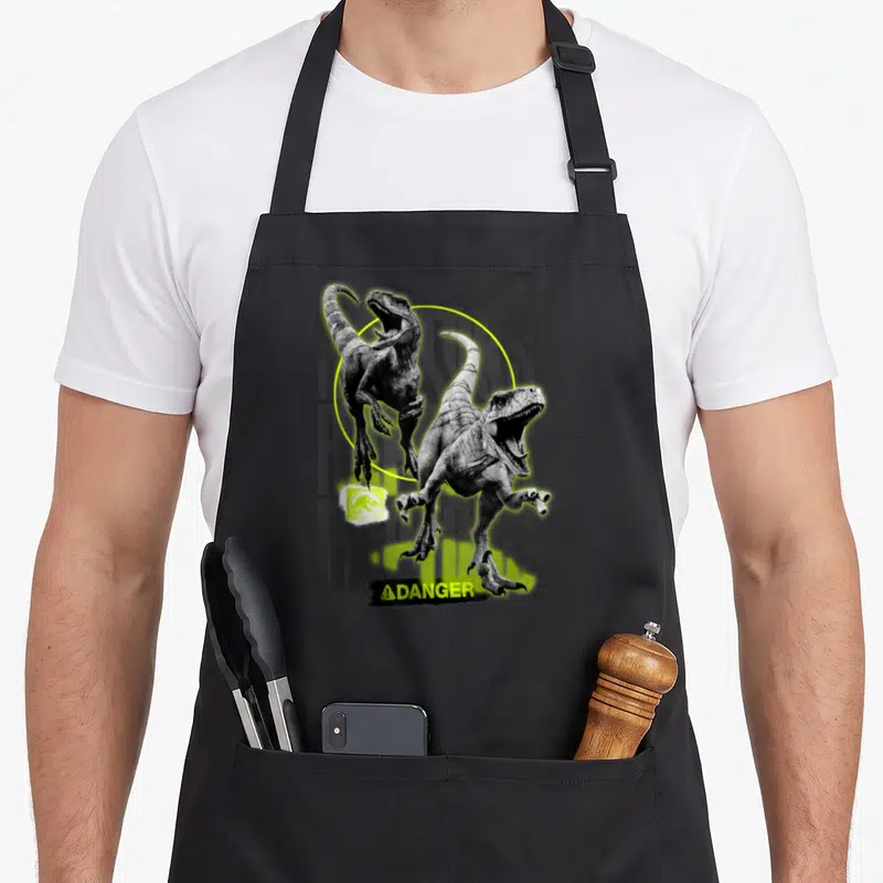 Tablier de cuisine noir avec deux raptors en noir et blanc, cercle vert fluo et texte Danger en bas.