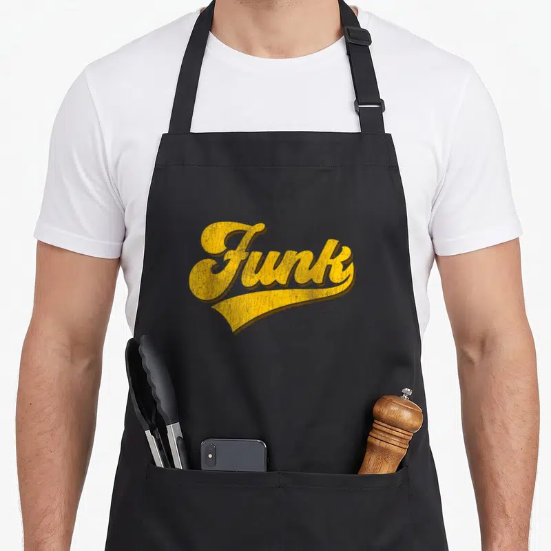 Tablier de cuisine noir avec le mot Funk écrit en lettres dorées style vintage et effet usé.