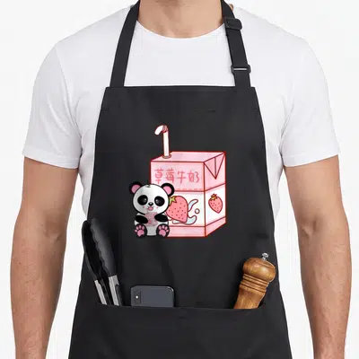 Tablier de cuisine noir avec illustration d'un carton de lait fraise rose et d'un petit pandatenant une boîte miniature.