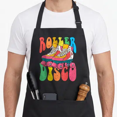 Tablier de cuisine noir avec illustration de patins à roulettes colorés et texte Roller Disco vintage