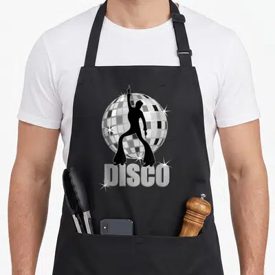 Tablier de cuisine noir avec silhouette danseuse, boule miroir et texte DISCO argenté.