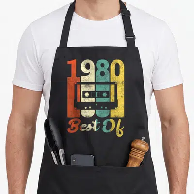 Tablier de cuisine noir avec illustration cassette 1980 Best Of couleurs délavées orange jaune et turquoise
