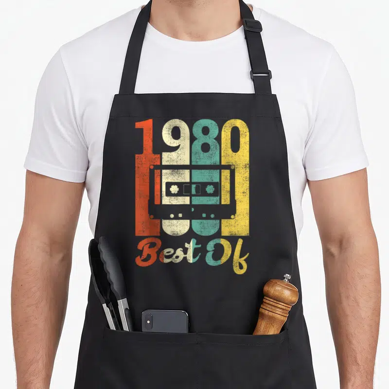 Tablier de cuisine noir avec illustration cassette 1980 Best Of couleurs délavées orange jaune et turquoise
