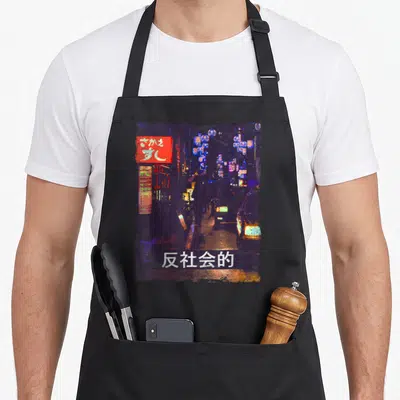 Tablier de cuisine noir avec illustration nocturne japonaise, lanternes bleues, enseigne rouge et texte blanc en bas.