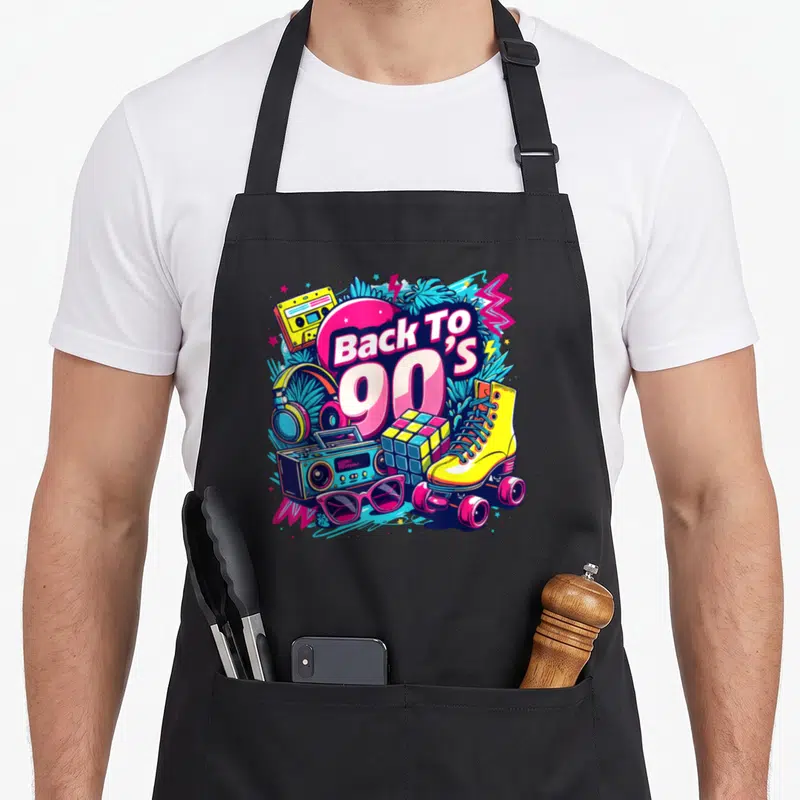 Tablier de cuisine noir avec illustration colorée Back To 90s incluant roller, boombox et cassette.