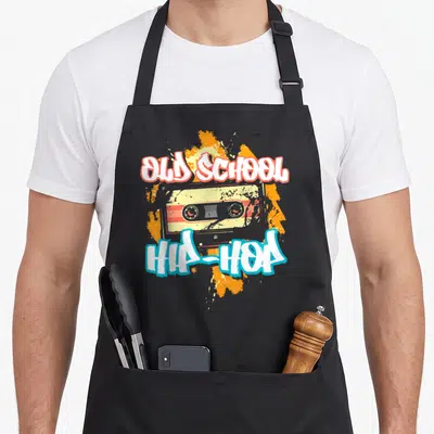 Tablier de cuisine noir avec illustration cassette audio Old School Hip-Hop et éclaboussures orange.