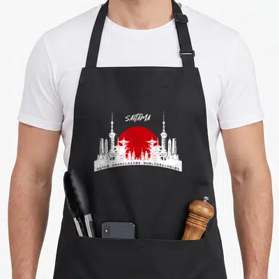 Tablier de cuisine noir avec skyline blanc, grand cercle rouge et texte Saitama en haut.