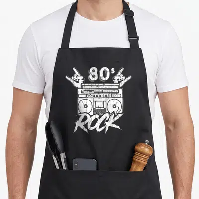 Tablier de cuisine noir avec illustration blanche d'une boombox 80s Rock et deux mains faisant le signe des cornes.