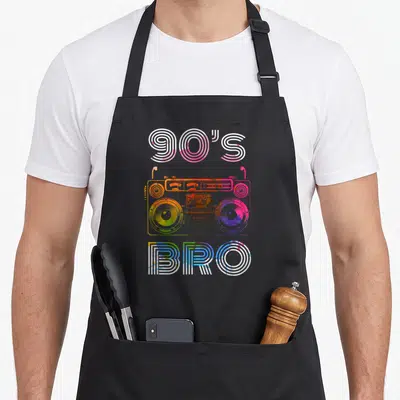 Tablier de cuisine noir avec illustration colorée d'une boombox et le texte 90's Bro en lettres stylisées.