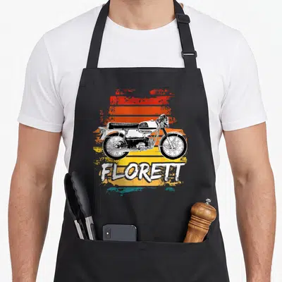 Tablier de cuisine noir avec illustration vintage d'un cyclomoteur Kreidler Florettt sur fond rayé orange et jaune.