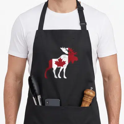 Tablier de cuisine noir avec illustration d'un caribou aux couleurs du drapeau canadien et effet vieilli.