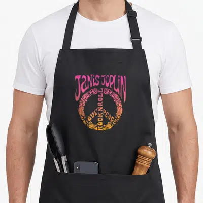 Tablier de cuisine noir avec logo Janis Joplin et symbole de paix rose orange en style Art Nouveau.