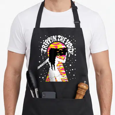 Tablier de cuisine noir avec illustration psychédlique Trappin The Void et silhouette aux motifs ondulés roses jaunes et noirs.