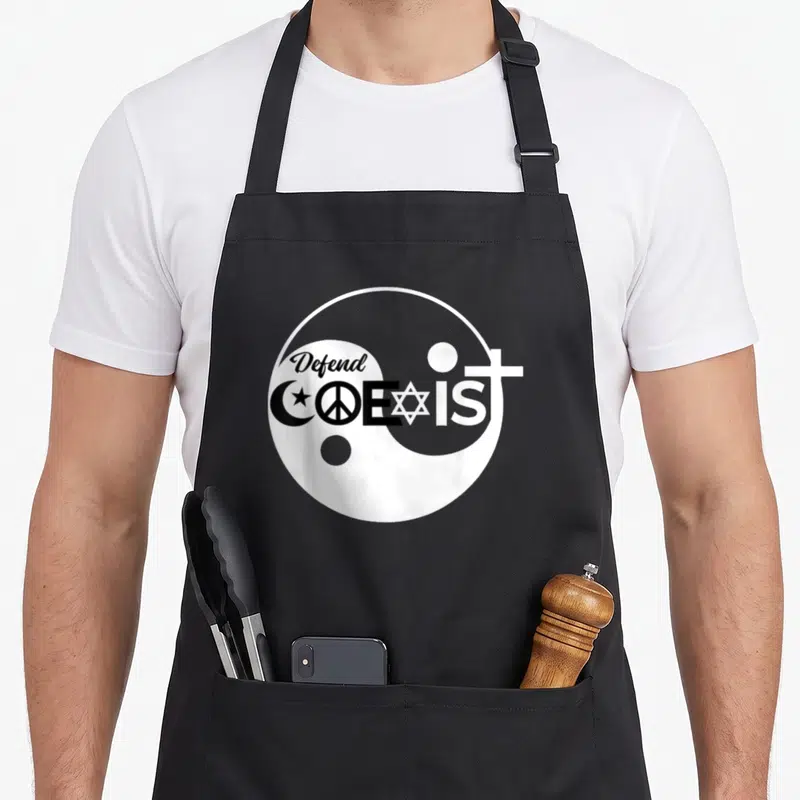 Tablier de cuisine noir avec logo blanc Defend Coexist combinant symboles religieux et Yin Yang.
