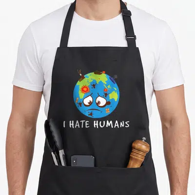 Tablier de cuisine noir avec une illustration d'une Terre malade et le texte I HATE HUMANS en blanc.