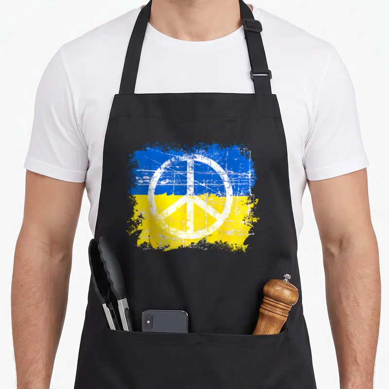 Tablier de cuisine noir avec drapeau ukrainien et symbole de la paix en style grunge.