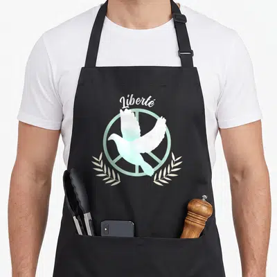 Tablier de cuisine noir avec colombe blanche et mint dans un signe de la paix, le mot Liberté en haut et des branches blanches en bas.