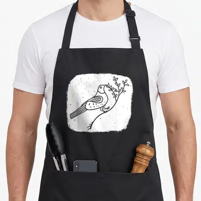 Tablier de cuisine noir avec colombe de la paix tenant une branche et les mots Amour Liberté Espoir imprimés en blanc.