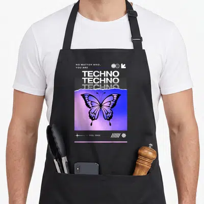 Tablier de cuisine noir avec grand papillon violet et texte TechnoFeel Free en blanc sur fond dégradé.