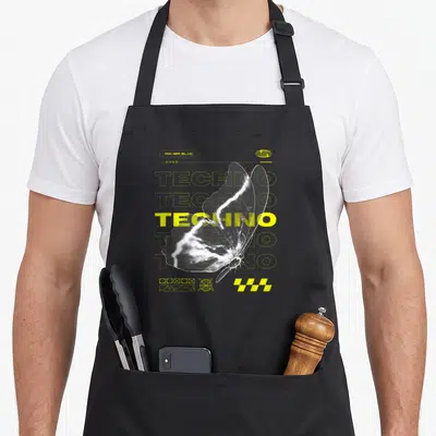 Tablier de cuisine noir avec un grand papillon blanc et du texte Techno en jaune vif sur fond sombre.