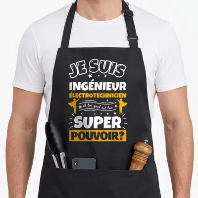 Tablier de cuisine noir avec inscription Je suis ingénieur électrotechnicien et toi quel est ton super pouvoir en blanc et orange.