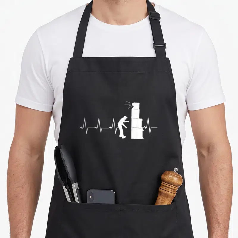 Tablier de cuisine noir avec silhouette blanche ajustant une colonne sonore sur un fond uni.