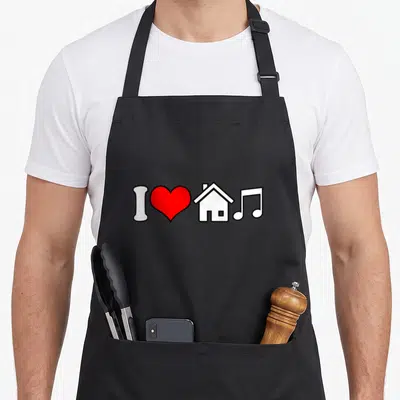 Tablier de cuisine noir avec un cœur rouge, une maison blanche et une note de musique stylisée.