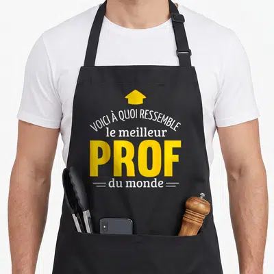 Tablier de cuisine noir avec inscription Voici à quoi ressemble le meilleur prof du monde et une flèche jaune pointant vers le haut.