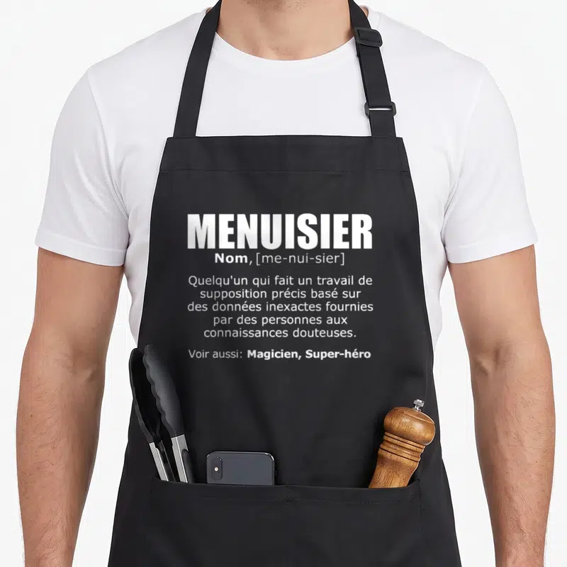 Tablier de cuisine noir avec définition textuelle blanche du terme menuisier et ses variantes magicien super-héro